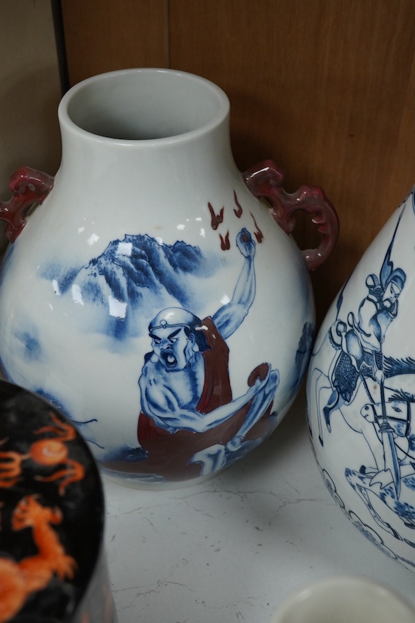 Three blue and white Chinese porcelain vases, a similar jar and cover, plus three stacking jars and covers on stand, a large dragon designed charger on stand and a similar decorated vase, charger 39cm diameter (7). Condi